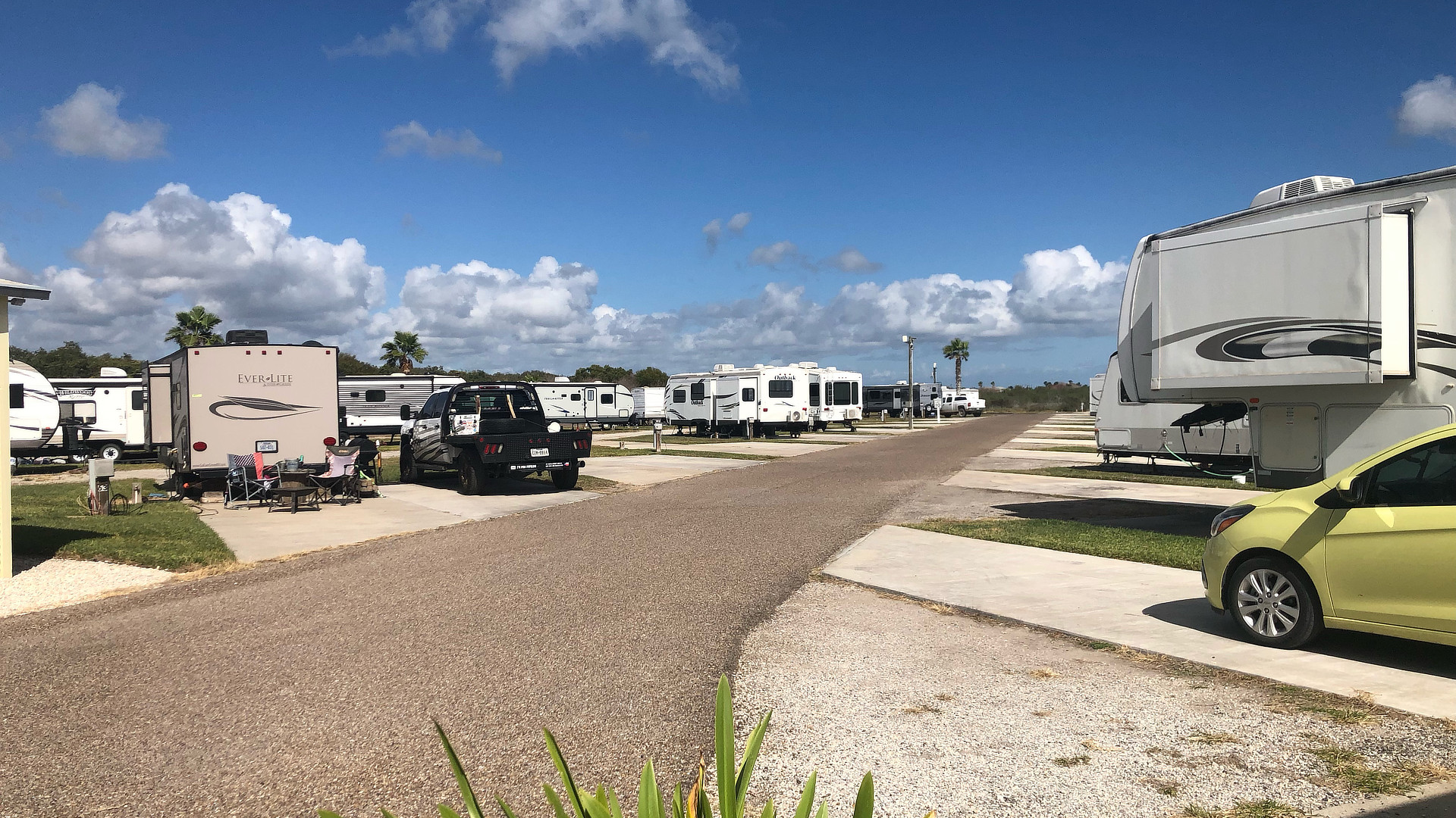 Sunny road with RVs parked on the side